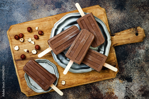 Vegan banana chocolate fudge popsicles with homemade hazelnut spread. Creamy dairy free ice pops, nicecream, fudgesicles photo