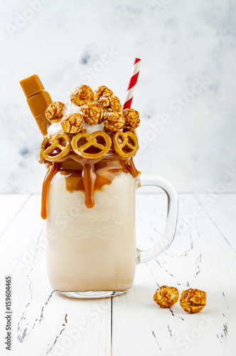 Quadro em tela Salted caramel indulgent exreme milkshakes with brezel waffles, popcorn and whipped cream