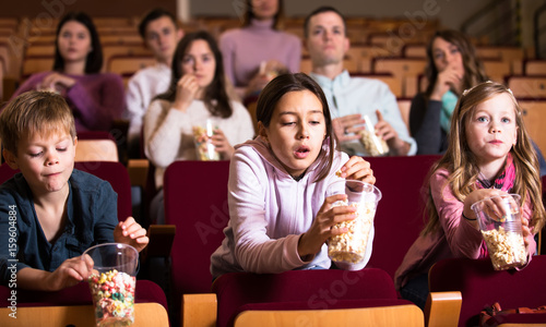 People eating popcorn in cinema