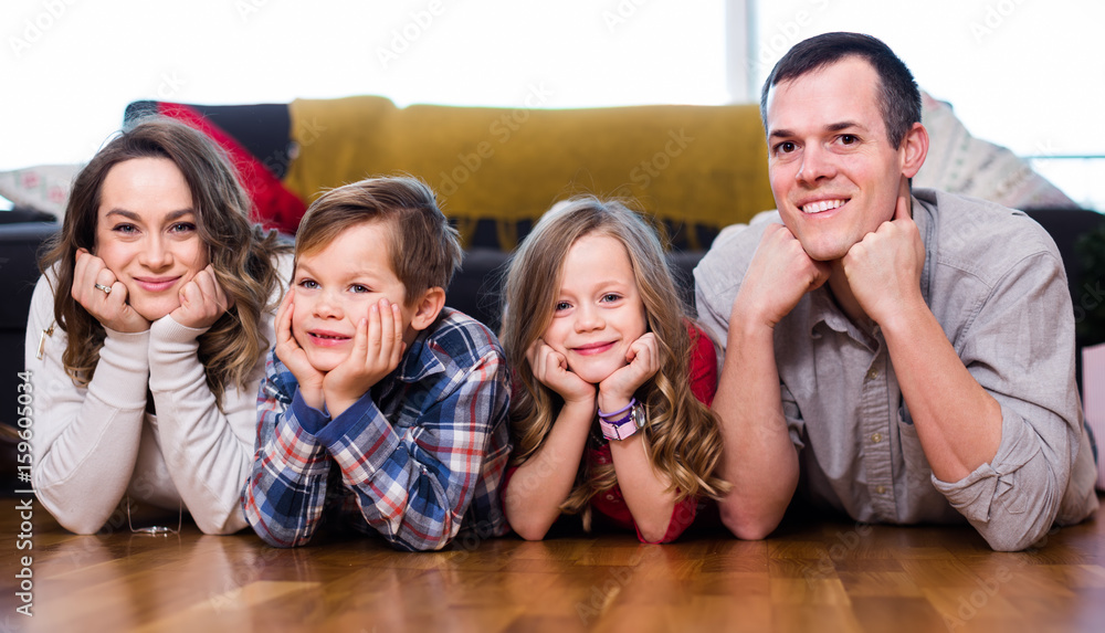 parents and two kids happy to spend time at home