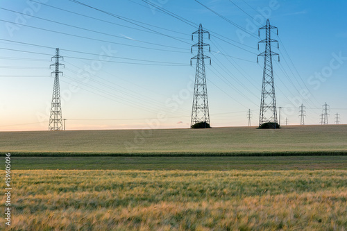 French countryside - Lorraine. High voltage line surrounded by wheat fields at sunset