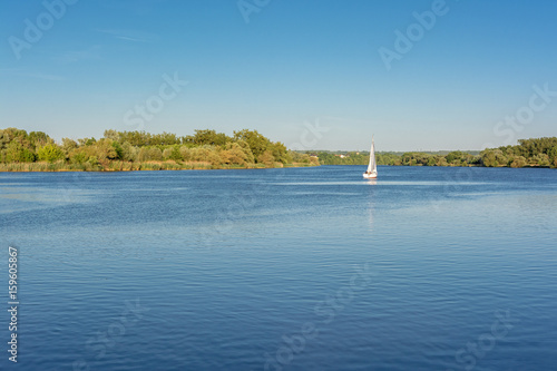 French countryside - Lorraine. A sailboat on the Moselle in the late evening.