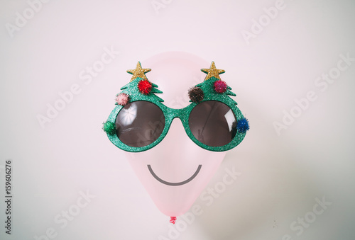 Christmas glasses that decoration with Christmas tree on air bolloon on white background