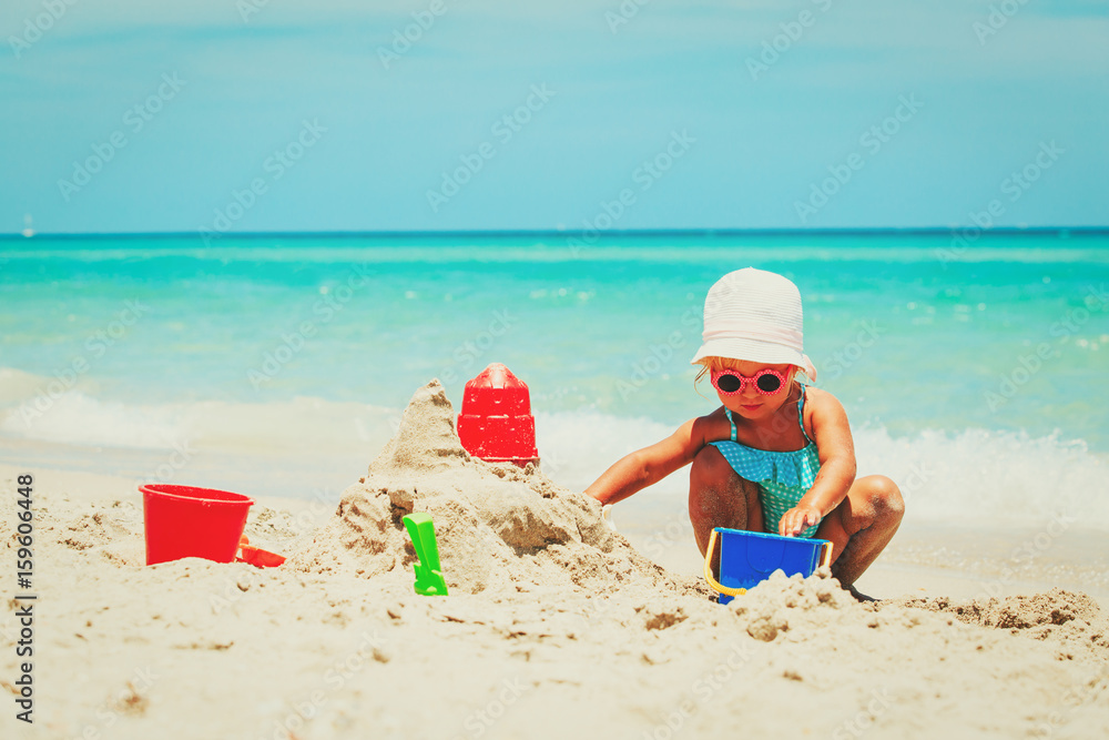 cute little girl play with sand on beach cute little girl play with sand on beach