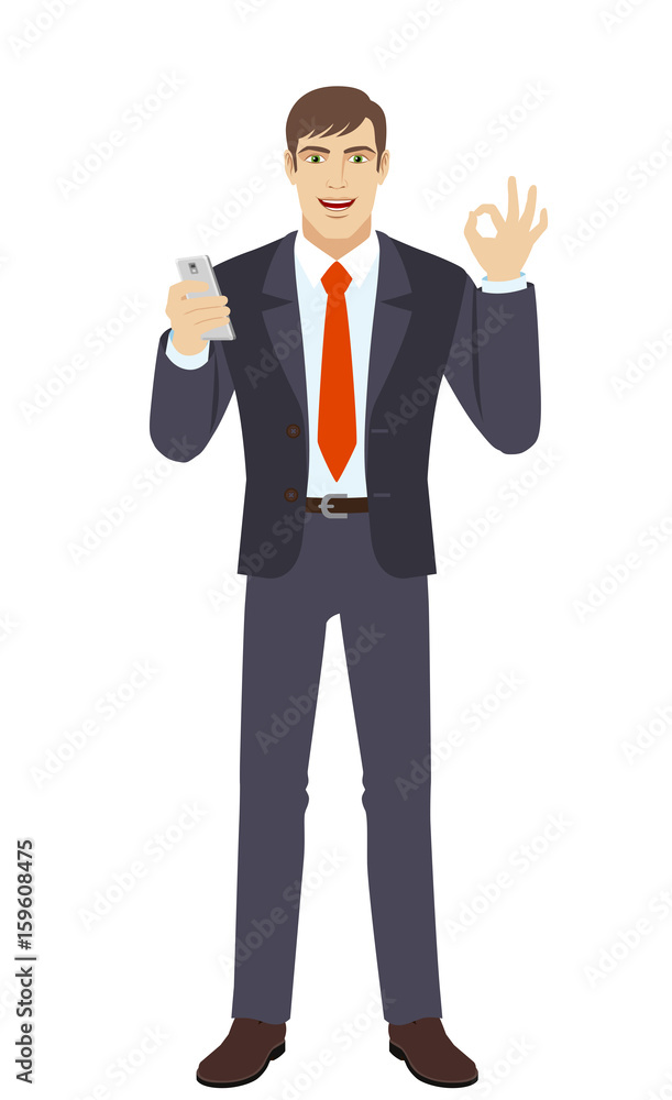 Businessman with mobile phone showing a okay hand sign Businessman with mobile phone showing a okay hand sign