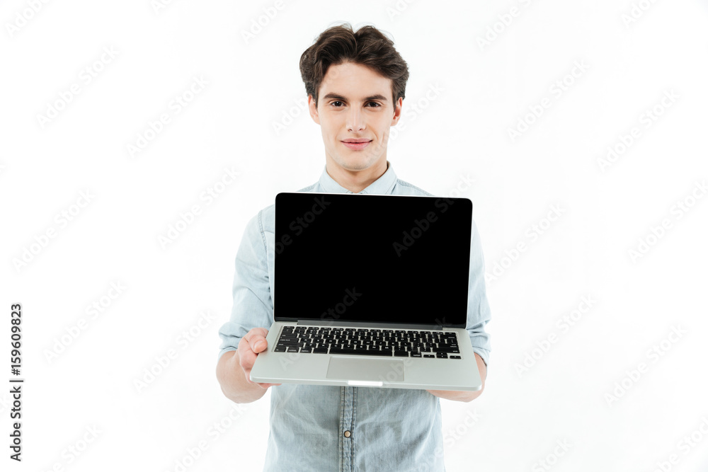 Portrait of a smiling man showing blank screen laptop computer Portrait of a smiling man showing blank screen laptop computer