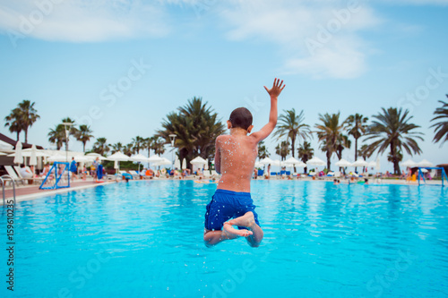 boy jumping in pool