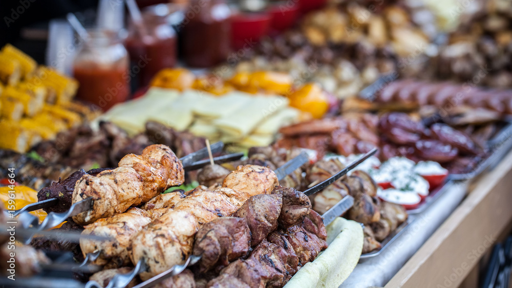 Food at the festival of street food, sausages, hot dog, fried potatoes, shish kebab, fried meat, fried corn and various drinks