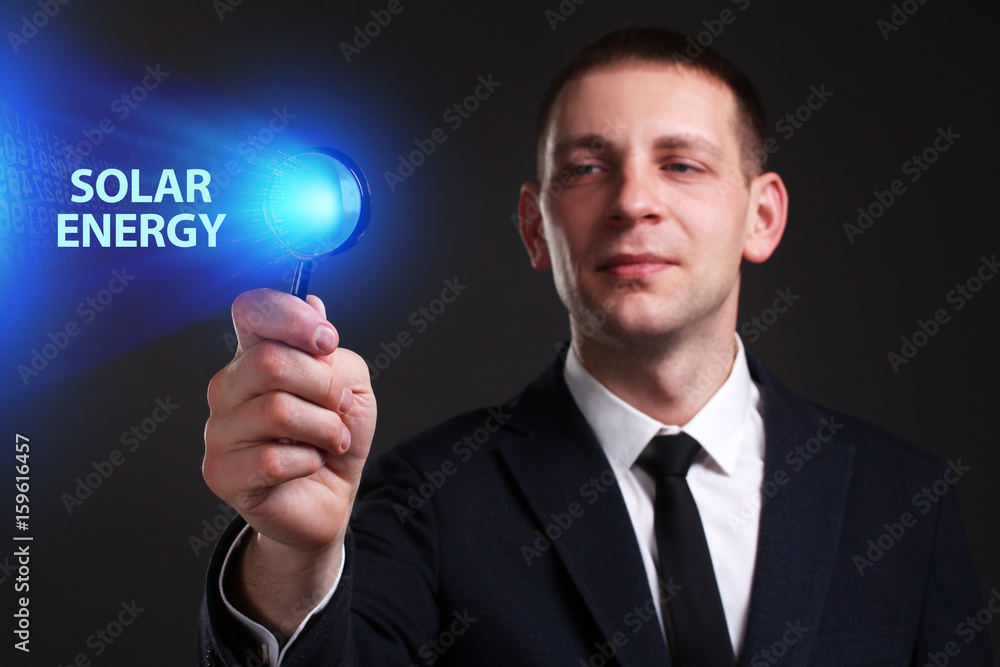 The concept of business, technology, the Internet and the network. A young entrepreneur working on a virtual screen of the future and sees the inscription: Solar energy The concept of business, technology, the Internet and the network. A young entrepreneur working on a virtual screen of the future and sees the inscription: Solar energy