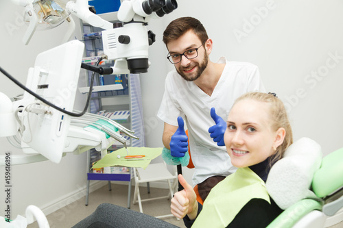 Smiling dentist and his cheerful patient