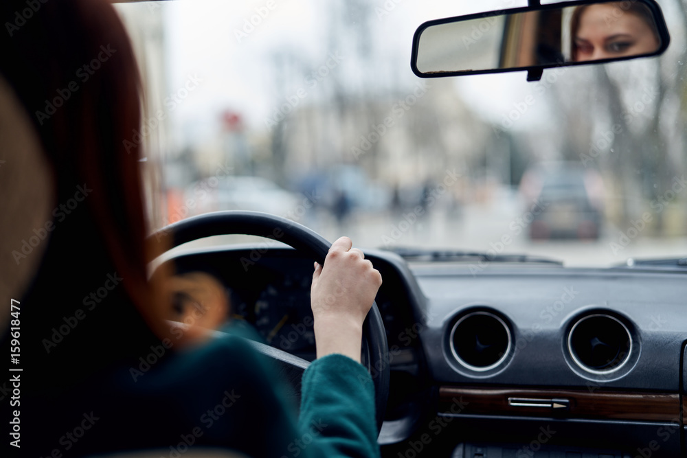 Woman driving a car, woman sitting behind the wheel of a car Woman driving a car, woman sitting behind the wheel of a car