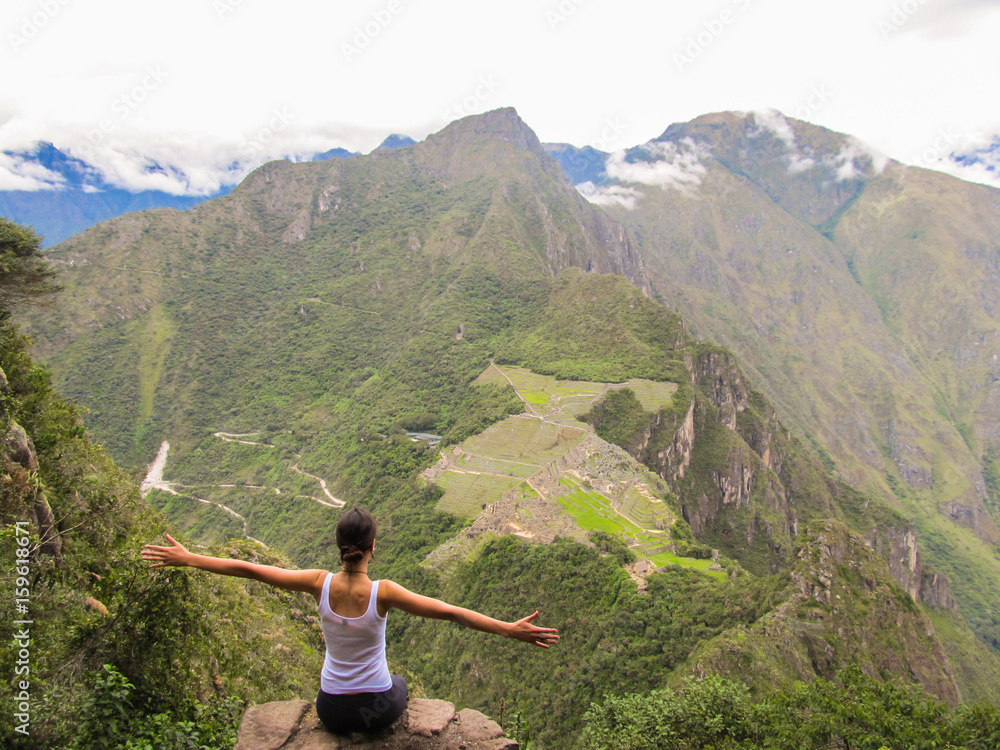 Naklejka premium Woman at the top of Wayna Picchu mountain in Machu Picchu, Peru