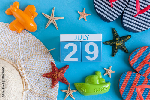 July 29th. Image of july 29 calendar with summer beach accessories and traveler outfit on background. Summer day, Vacation concept