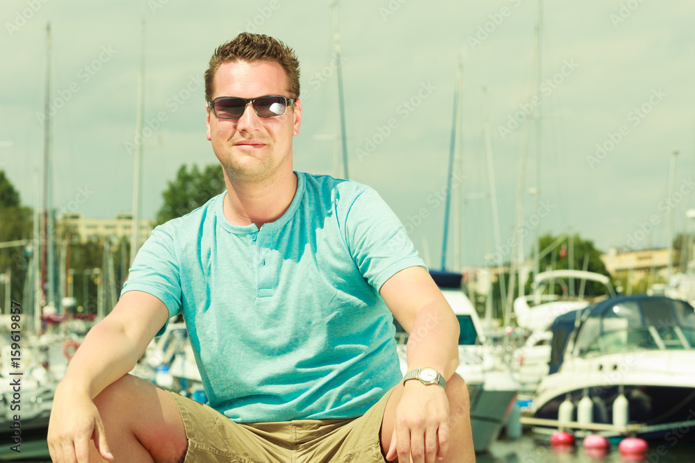 Man walking on marina during summer Man walking on marina during summer