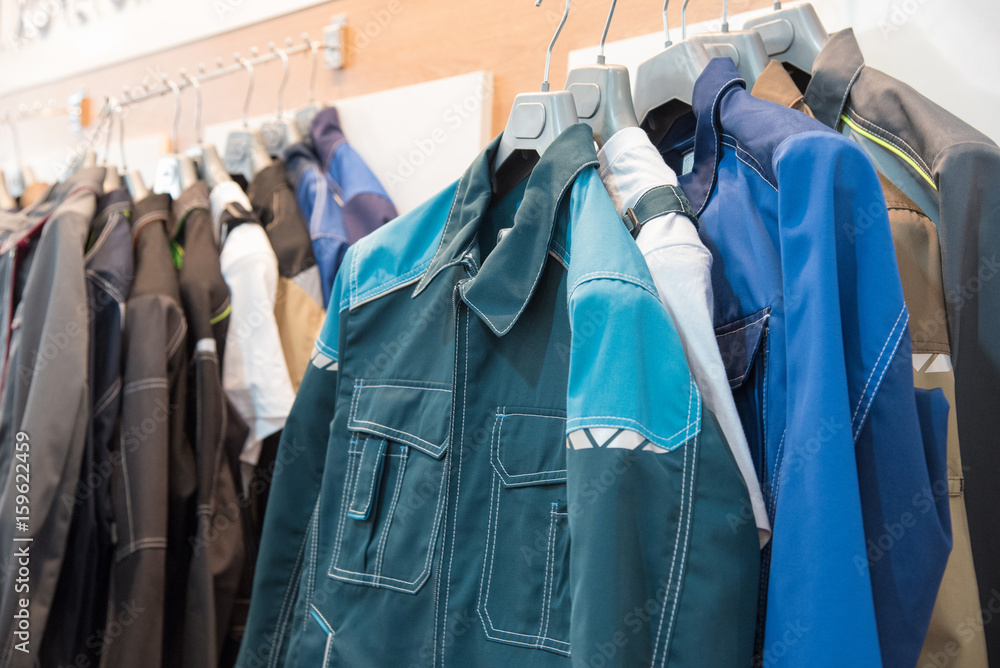 © Oksana Bessonova - The upper work clothes of strong fabric of different colors with pockets hang on the hangers as a sample © Oksana Bessonova - The upper work clothes of strong fabric of different colors with pockets hang on the hangers as a sample