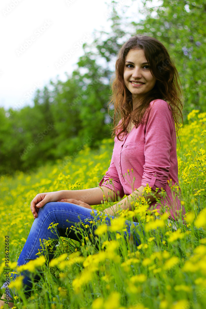 Lovely girl in a field of sunflowers holding a bouquet of flowers . Lovely girl in a field of sunflowers holding a bouquet of flowers .
