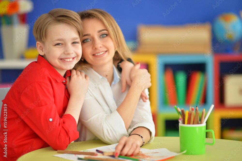 Fototapeta premium Mother with her son draw with pencils