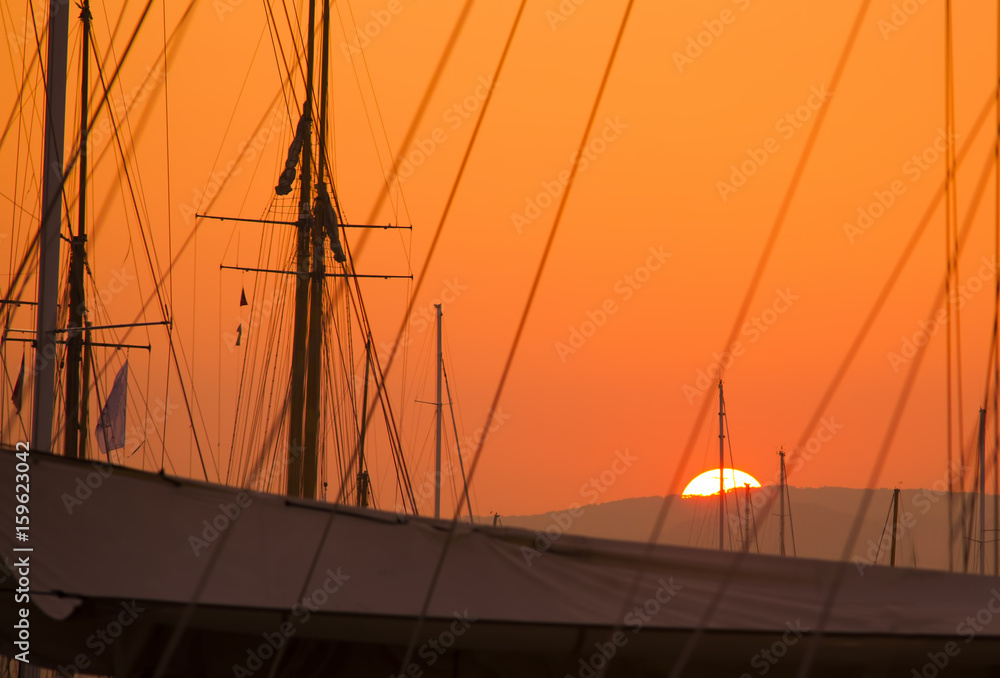 sunset view of the sailboats in port