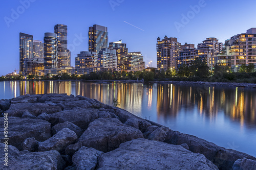 Toronto's west end cityscape (condo buildings lit up at nighttime near the lake shore). photo