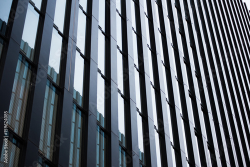 Wallpaper Mural Underside panoramic and perspective view to steel blue glass high rise building. Modern skyscrapers in business district in light at sunset. Torontodigital.ca