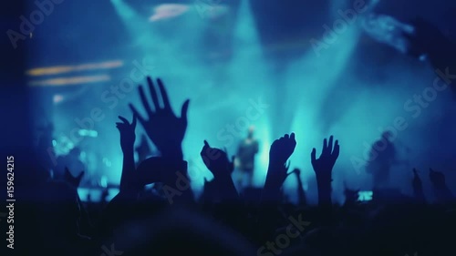 Iconic night rock concert front row crowd cheering hands in air slomo 100p