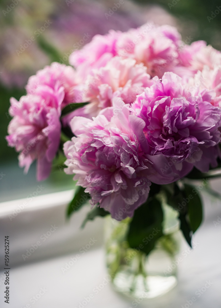 Amazing vibrant bouquet of blooming purple peonies.