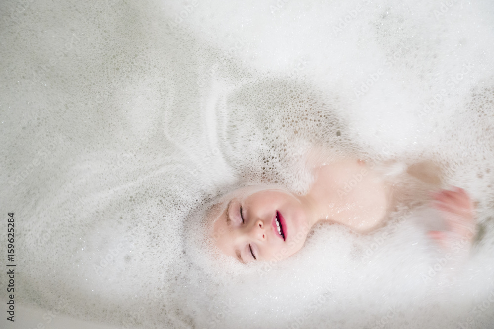 Girl (2-3) lying in bathtub Girl (2-3) lying in bathtub