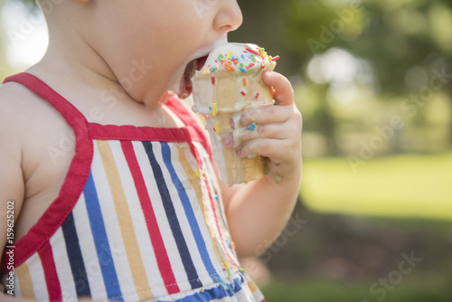 Baby girl (18-23 months) eating ice-cream photo