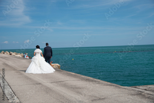 Married couple walking on the pier