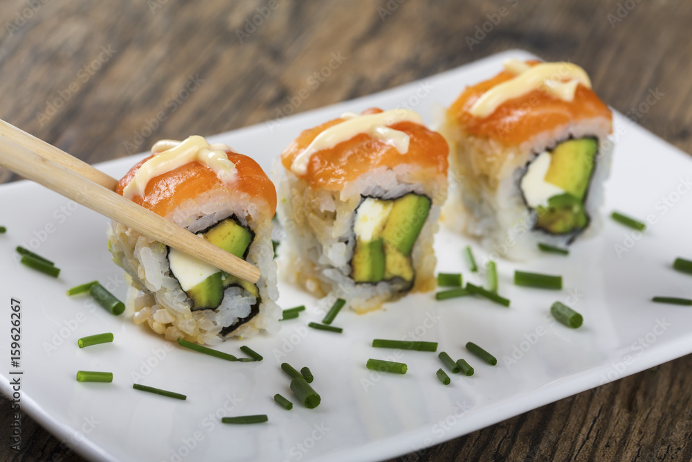 Delicious mixed sushi arranged on white marble surface Delicious mixed sushi arranged on white marble surface