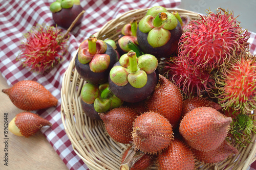 Tropical fruits in a basket  rambutan  salacca  palm fruit  and mangosteen