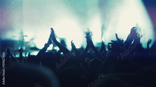 Iconic night rock concert front row crowd cheering hands in air slomo 100p