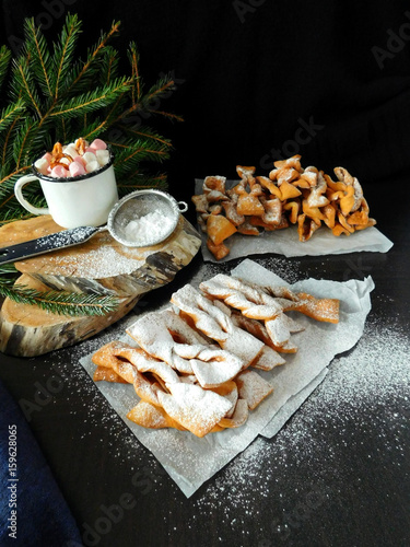 Homemade khvorost cookies are covered with sugar powder photo