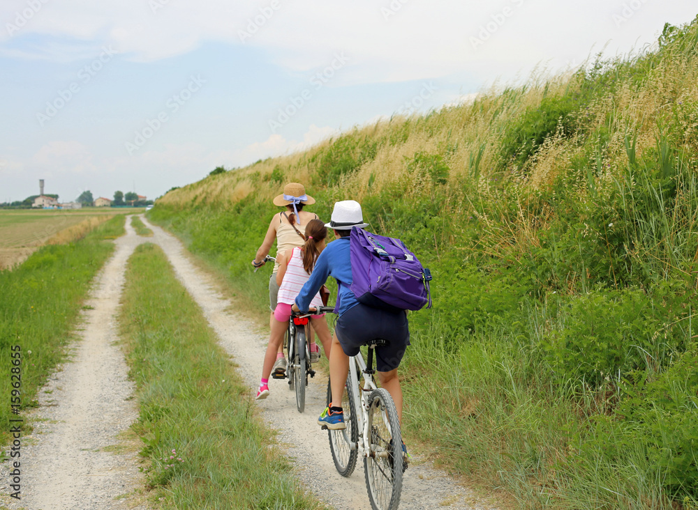 Three people with two bicycles along the cycle path