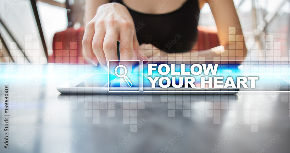 Woman using tablet pc and selecting follow your heart.