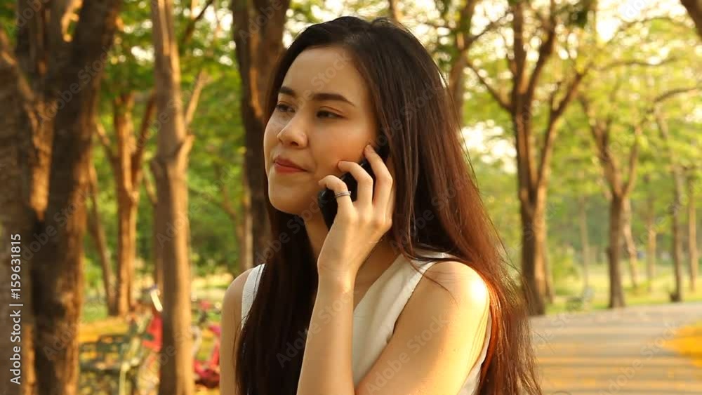 Thai pretty woman talkative with smartphone Thai pretty woman talkative with smartphone
