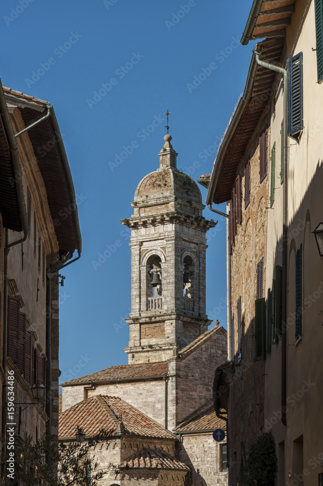 SAN QUIRICO D'ORCIA, ITALY - OCTOBER 30, 2016 - Charming narrow street in the town of San Quirico d'Orcia, province of Siena, Val d'Orcia, Tuscany, Italy