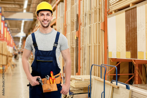 Carpenter with tool belt at...