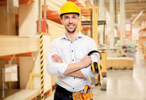 Carpenter with tool belt at...