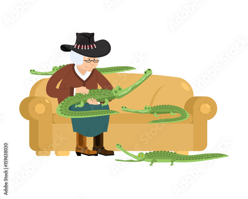 Australian grandmother and crocodile. Australia old woman and an alligator pet. grandma in hat on couch. Crocodile farm. gammer breeds wild reptiles and predators