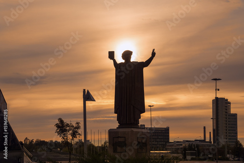 Monument to Francysk Skaryna near National Library. Against the setting sun. Humanist, physician, translator and one of the first book printers in Eastern Europe photo