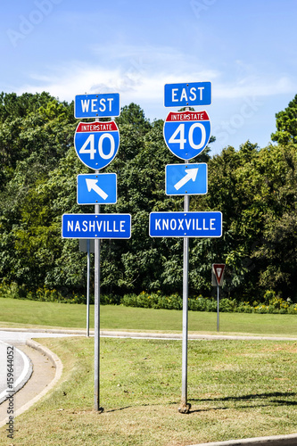 Two signs at interstate 40 in Tennesse. West to Nashville and East to Knoxville photo