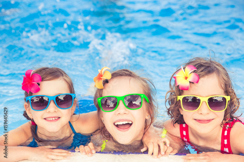 Happy children in the swimming pool © Sunny studio
