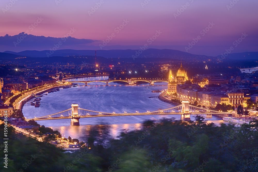 Naklejka premium Budapest Panorama with parliament and bridges during blue hour sunset. View from Citadel