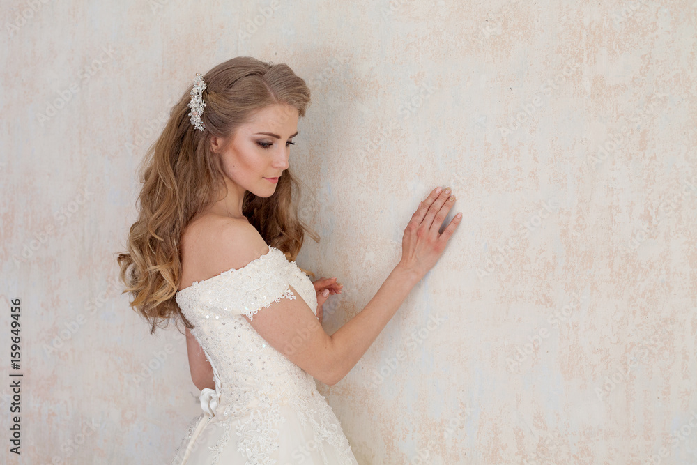 Fototapeta premium a portrait of the bride before the wedding in white dress