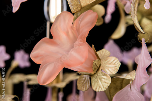 Classic chandelier in flower style isolated on black background. Details photo