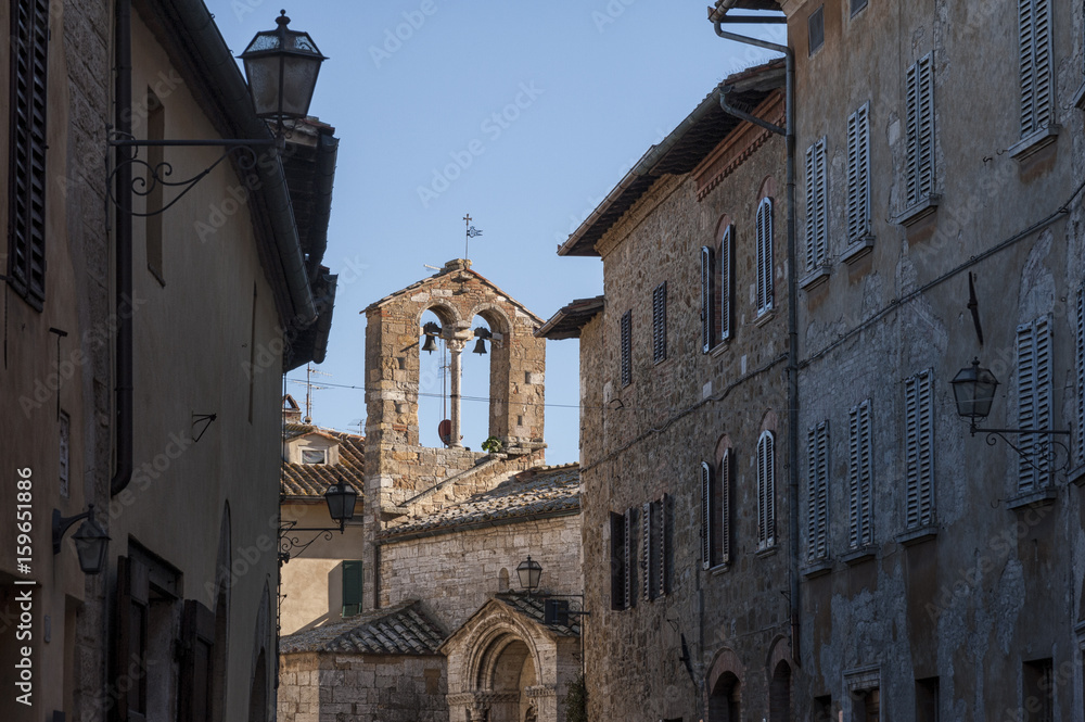 SAN QUIRICO D'ORCIA, ITALY - OCTOBER 30, 2016 - Charming narrow street in the town of San Quirico d'Orcia, province of Siena, Val d'Orcia, Tuscany, Italy