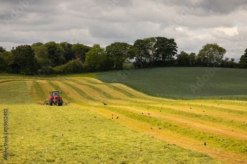 Red tractor mowing Irish field