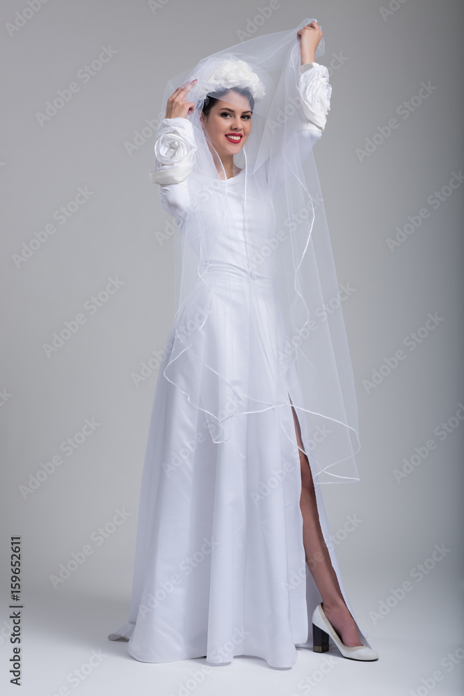 young bride in a wedding dress with a veil young bride in a wedding dress with a veil