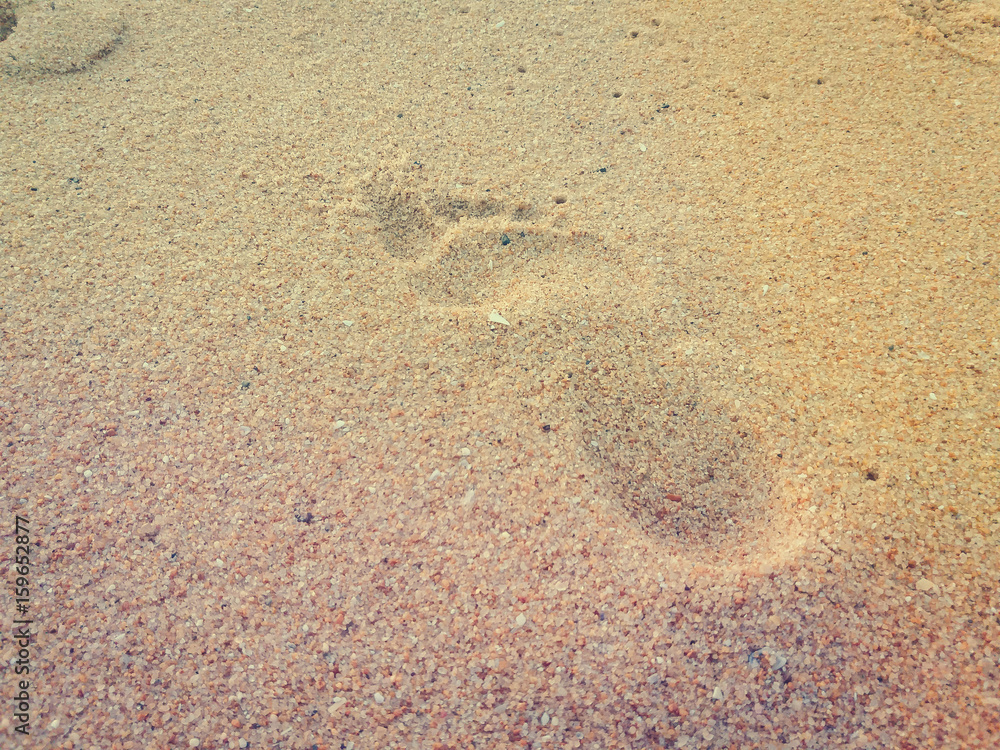 Natural background of human footprint in the wet sandy seaside. Close-up photography on relaxation sign idea design Natural background of human footprint in the wet sandy seaside. Close-up photography on relaxation sign idea design